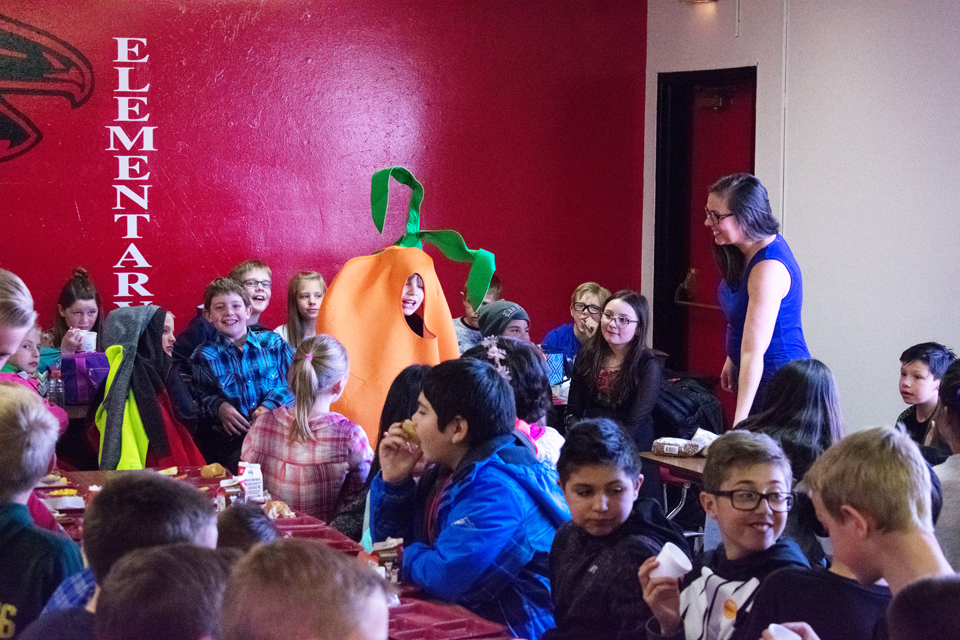Keenan Waldroup poses in a carrot costume in front of his peers at the Harvest of the Month event.